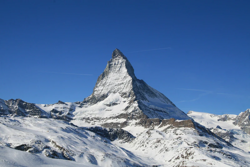 The Matterhorn under a blue sky above the snow-covered slopes near Zermatt