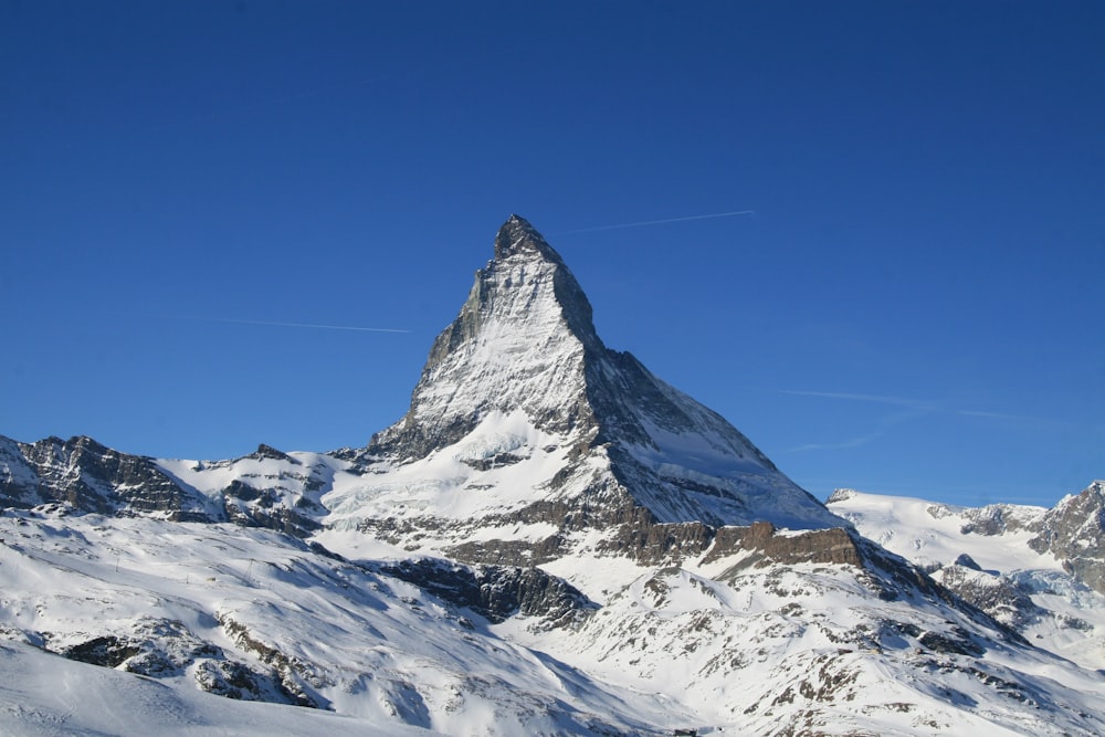 snow covered mountain under blue sky during daytime