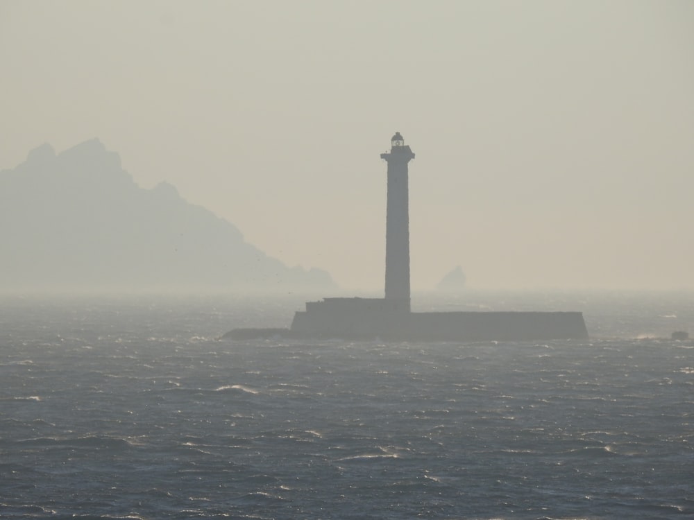 black and white lighthouse on top of the hill