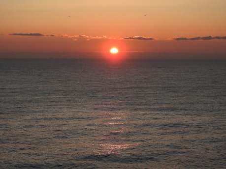 body of water during sunset
