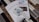 A stack of brochures for Cottonwood Apartments is placed on a tiled surface. On top of the brochures, there is a key with a logo that features a house and the words 'Apartments Near Me'. The brochures include contact information and a picture of the apartment interior.