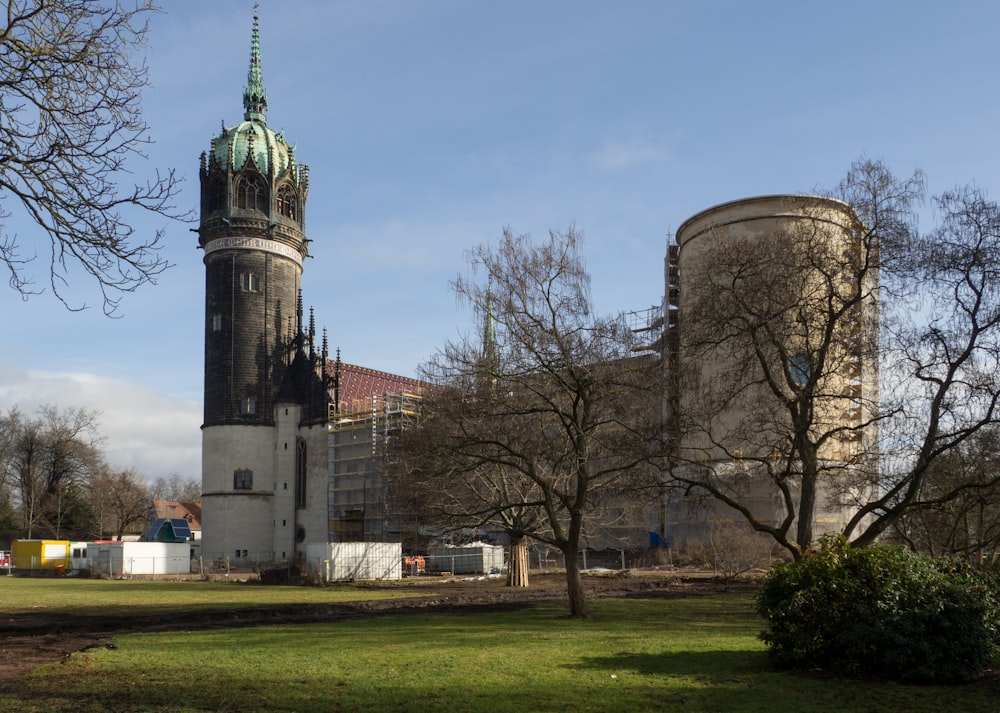 brown and gray concrete building near bare trees under blue sky during daytime