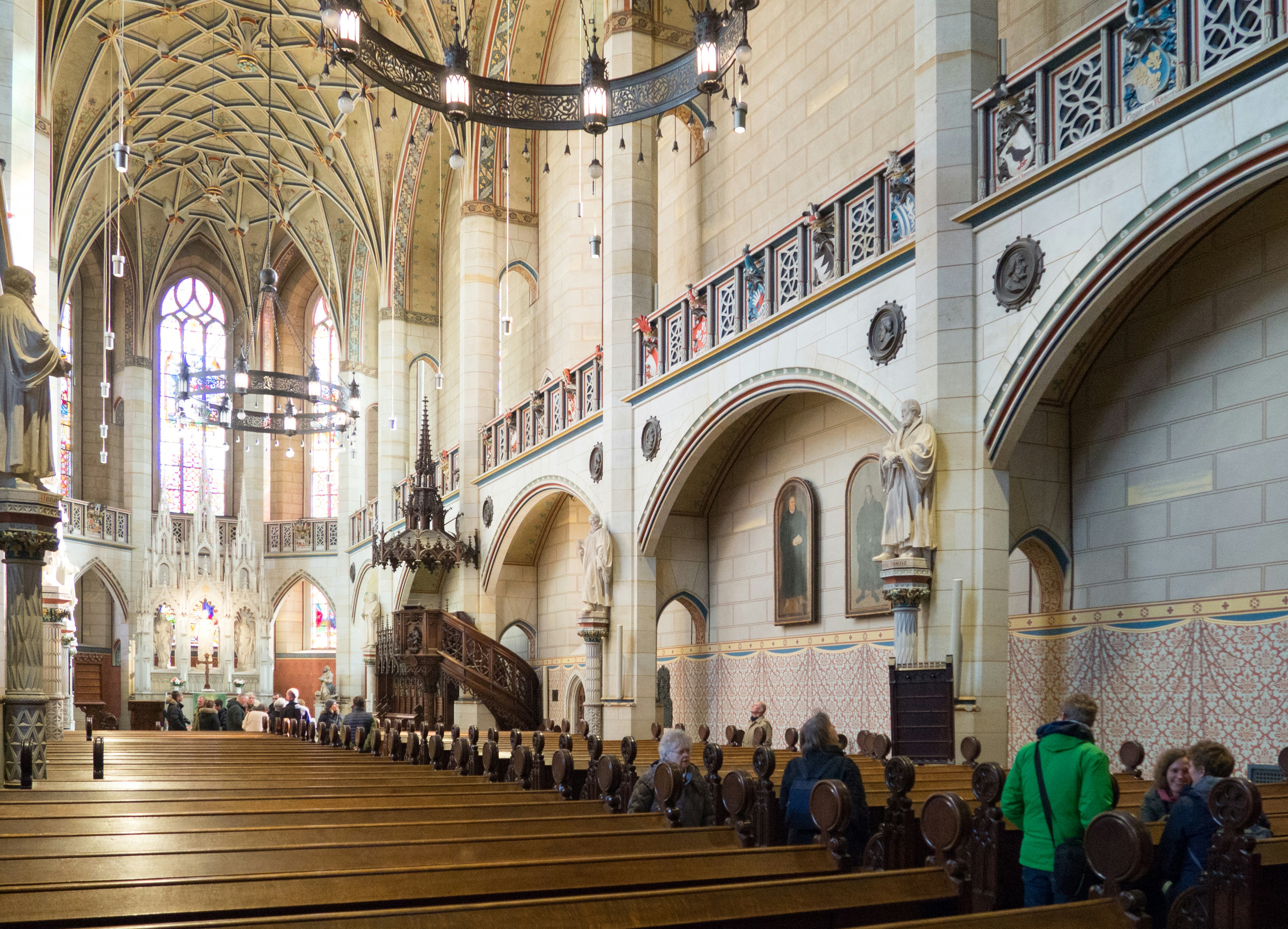 People sitting on brown wooden bench inside church - religious history sites