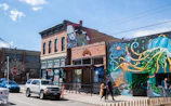 A lively street scene with colorful murals reflecting creative energy.