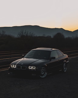 black mercedes benz coupe on road during daytime