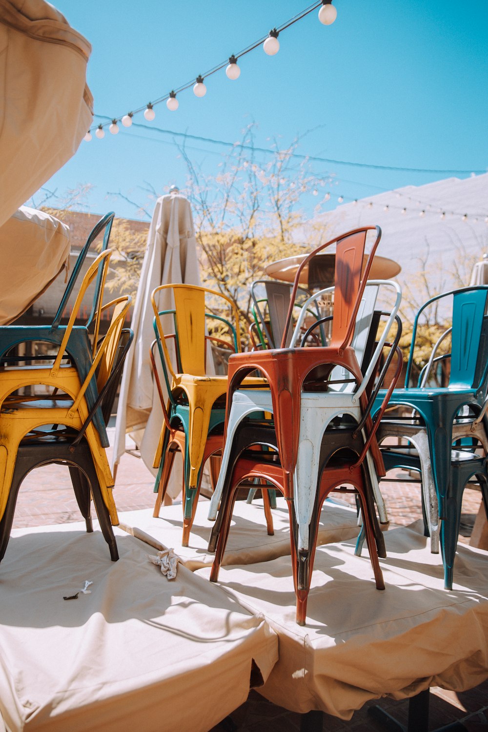 brown wooden chairs on white sand during daytime