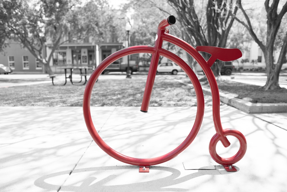 red metal stand on white concrete floor