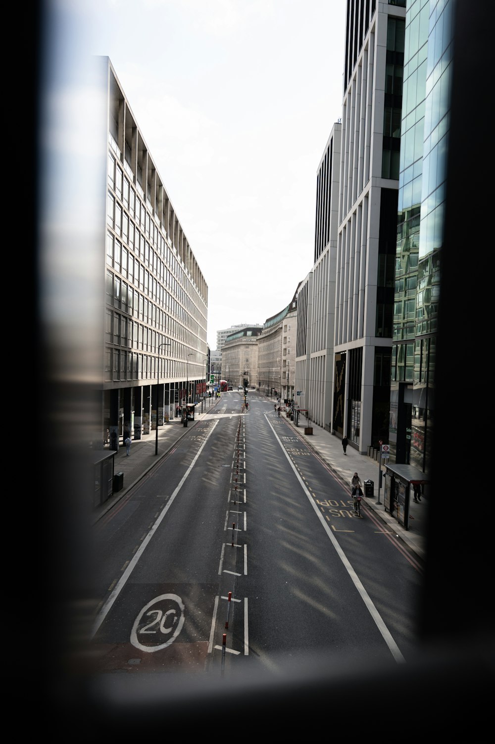 gray concrete road between buildings during daytime