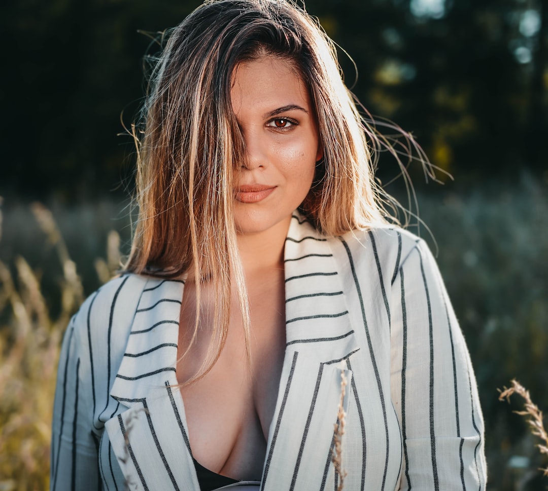 woman in white long sleeve shirt smiling