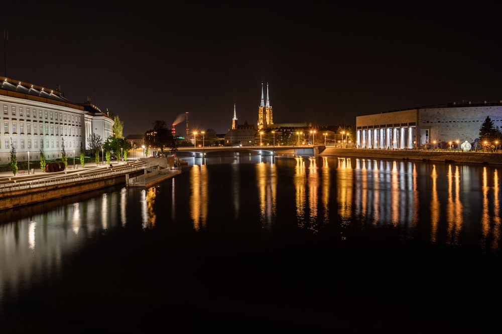 body of water near building during night time