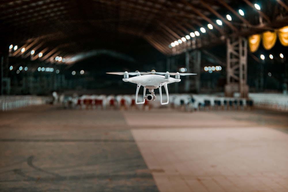 white and black drone in a building