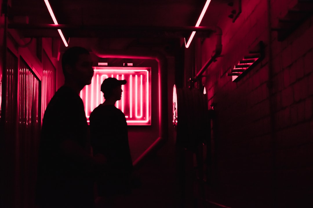 man and woman standing in front of red light