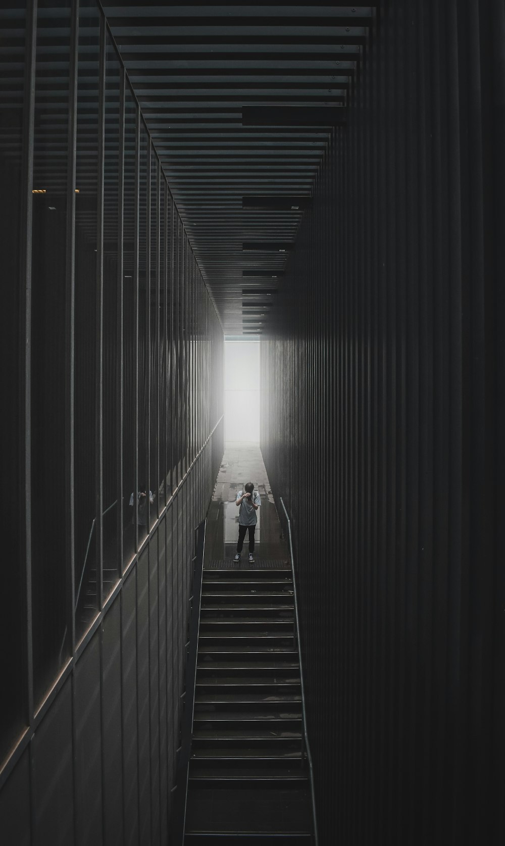 man in black shirt walking on the stairs