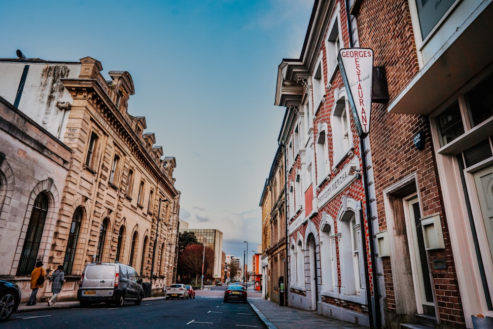 cars parked beside brown concrete building during daytime