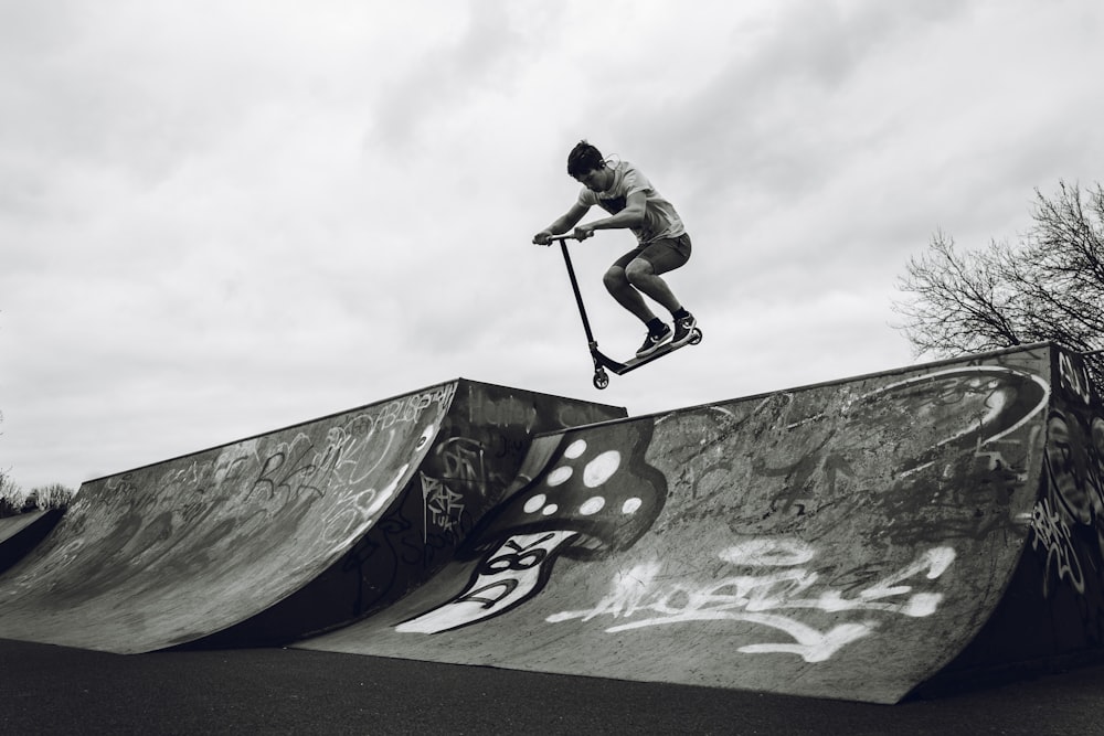 man in black shirt and pants riding skateboard on skateboard during daytime