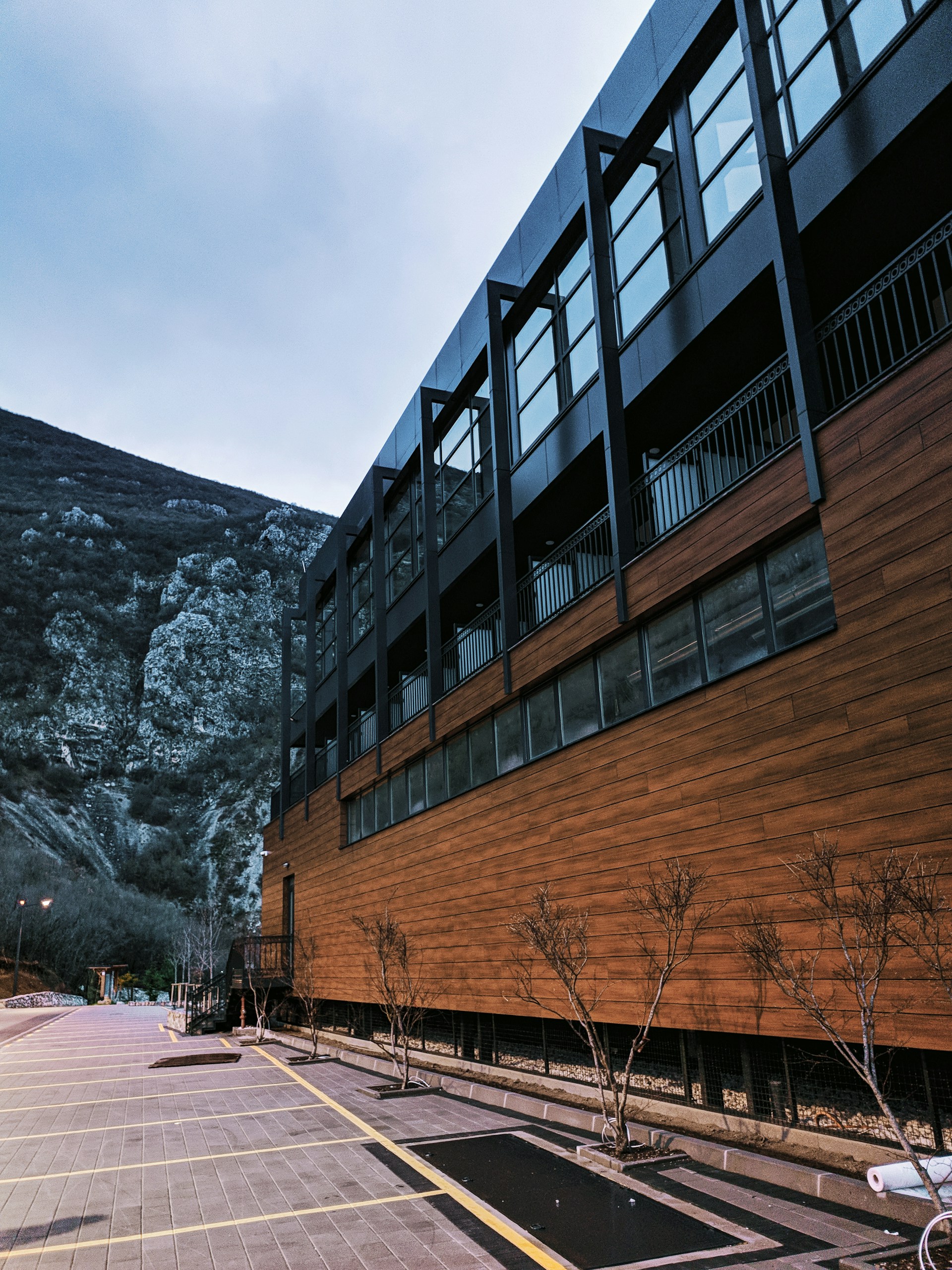 brown wooden building near gray rocky mountain during daytime