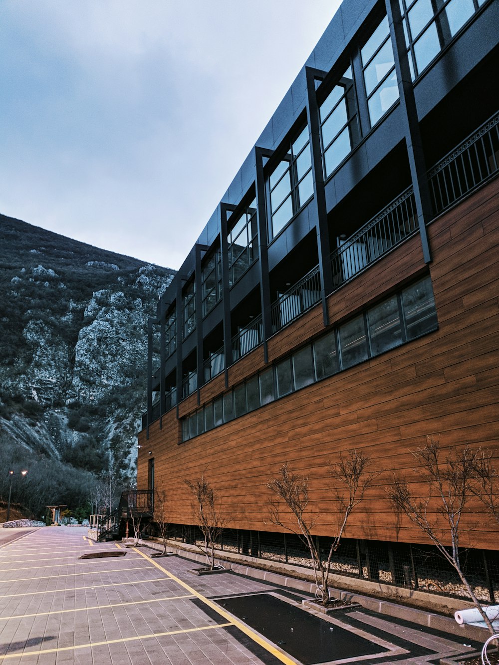 brown wooden building near gray rocky mountain during daytime