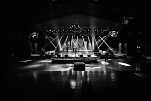 grayscale photo of stage with lights