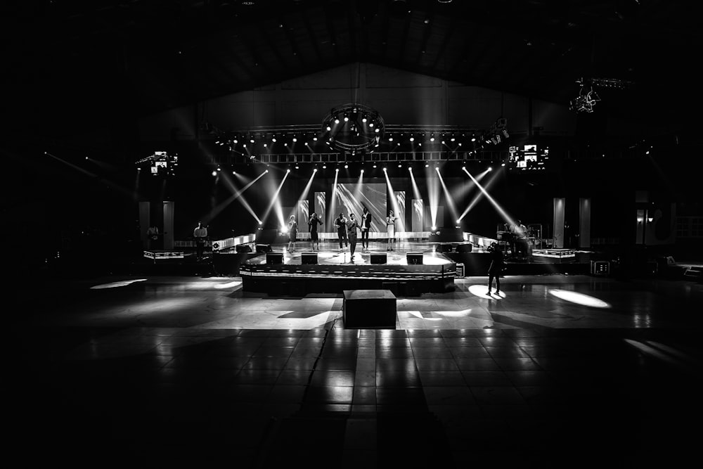 grayscale photo of stage with lights