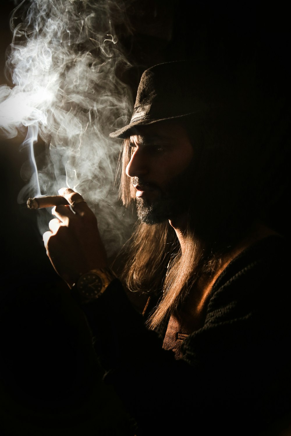 woman in black knit cap smoking