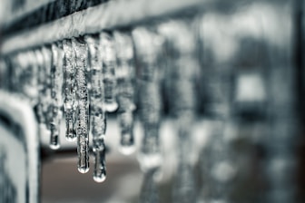 water droplets on gray metal pipe