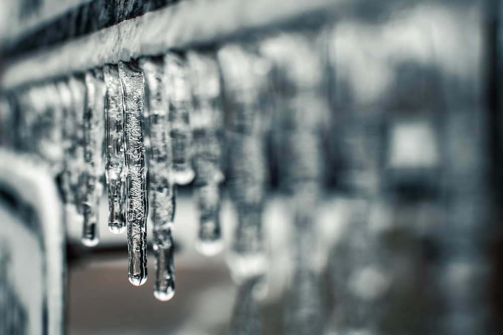 water droplets on gray metal pipe