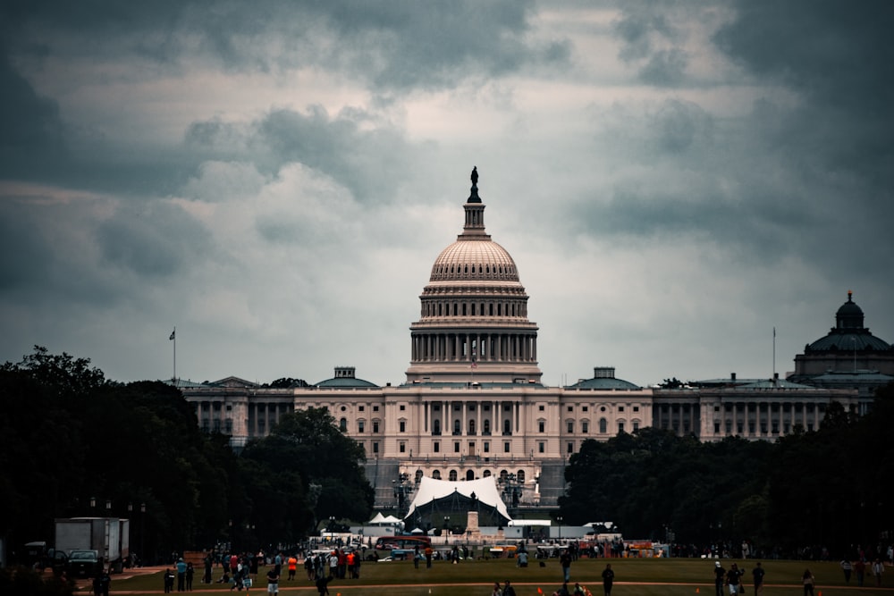 white concrete building under gray clouds during daytime