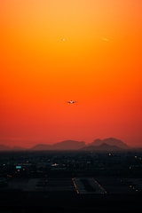 airplane flying over city during daytime