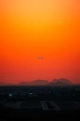 airplane flying over city during daytime