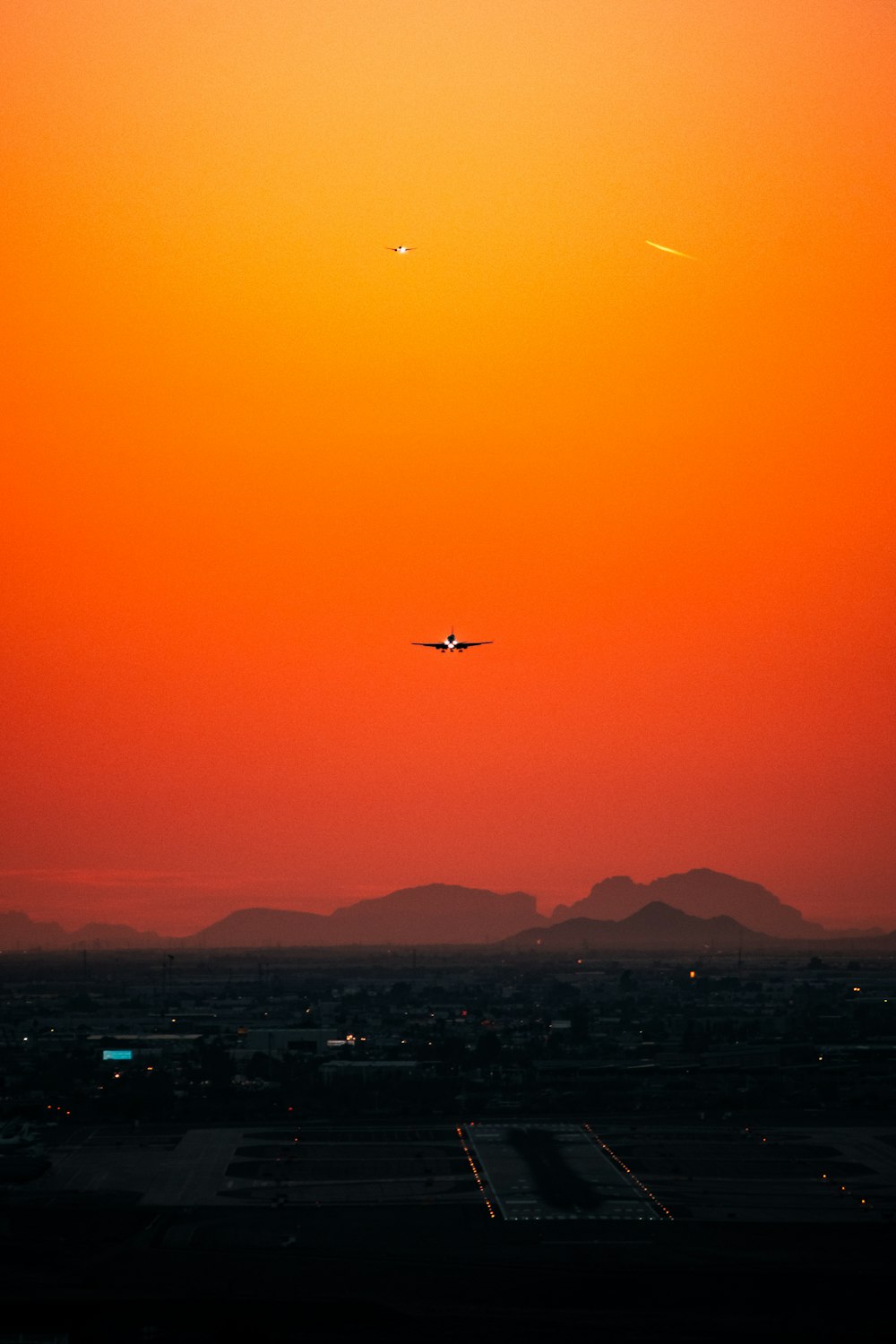 airplane flying over city during daytime