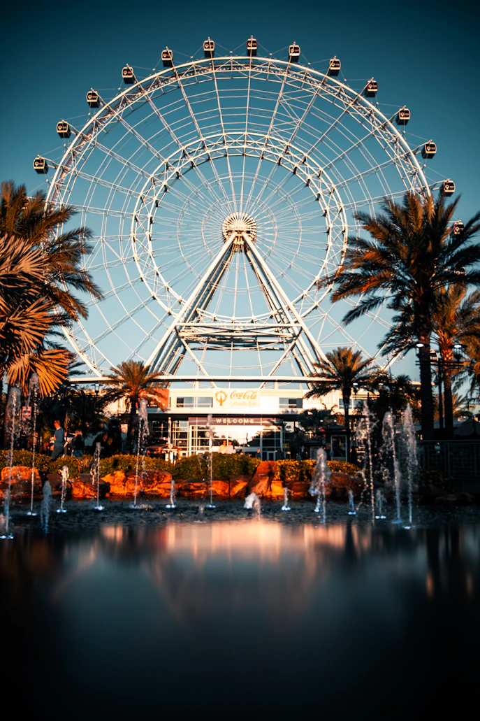 Vibrant look looking upward at the grand, structured frame of the large observation wheel against a clear blue sky