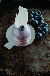 Close-up of a luxurious dessert elegantly dusted with vibrant purple ube powder on fine porcelain.