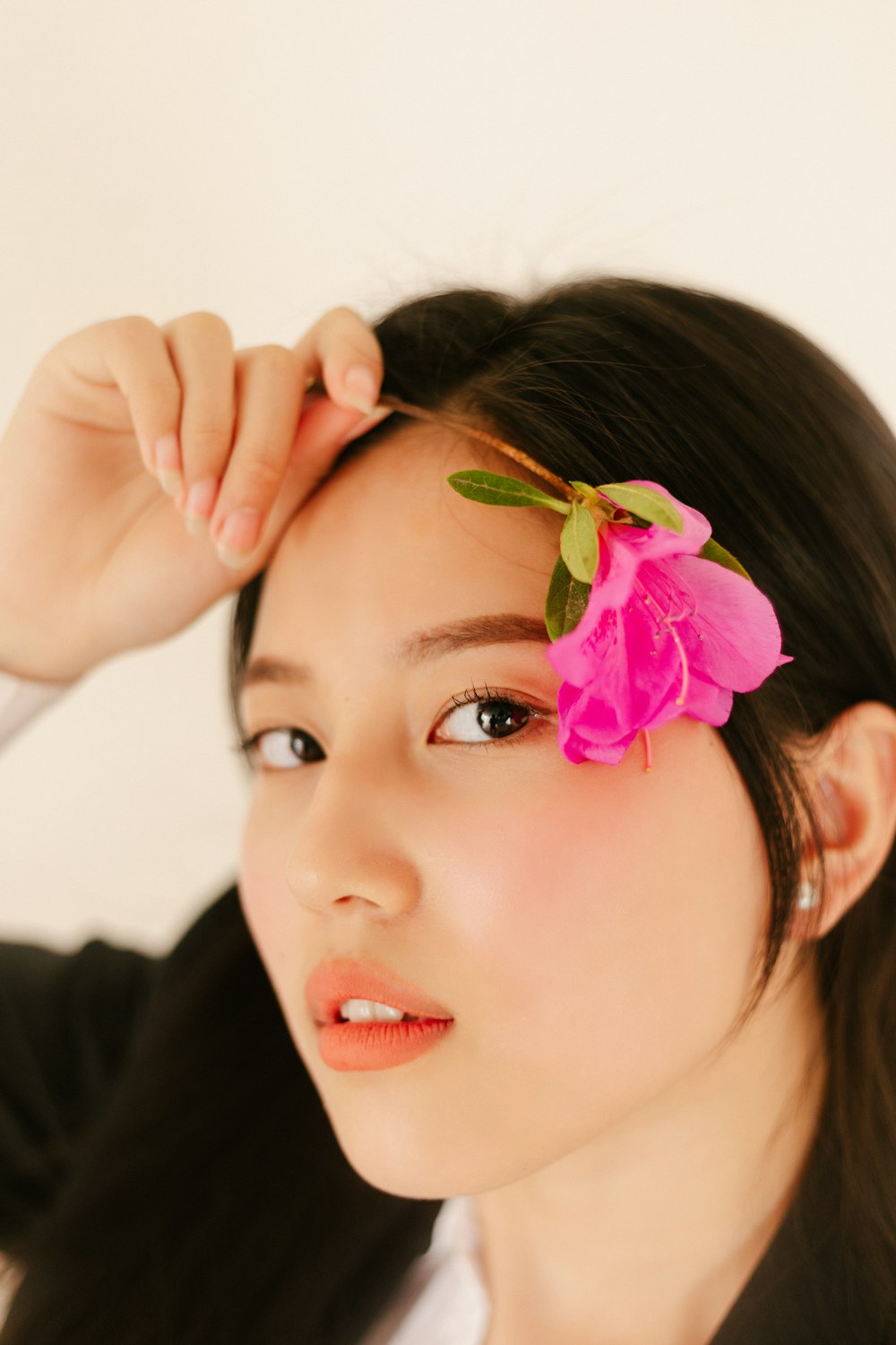 woman in black long sleeve shirt with purple flower on ear