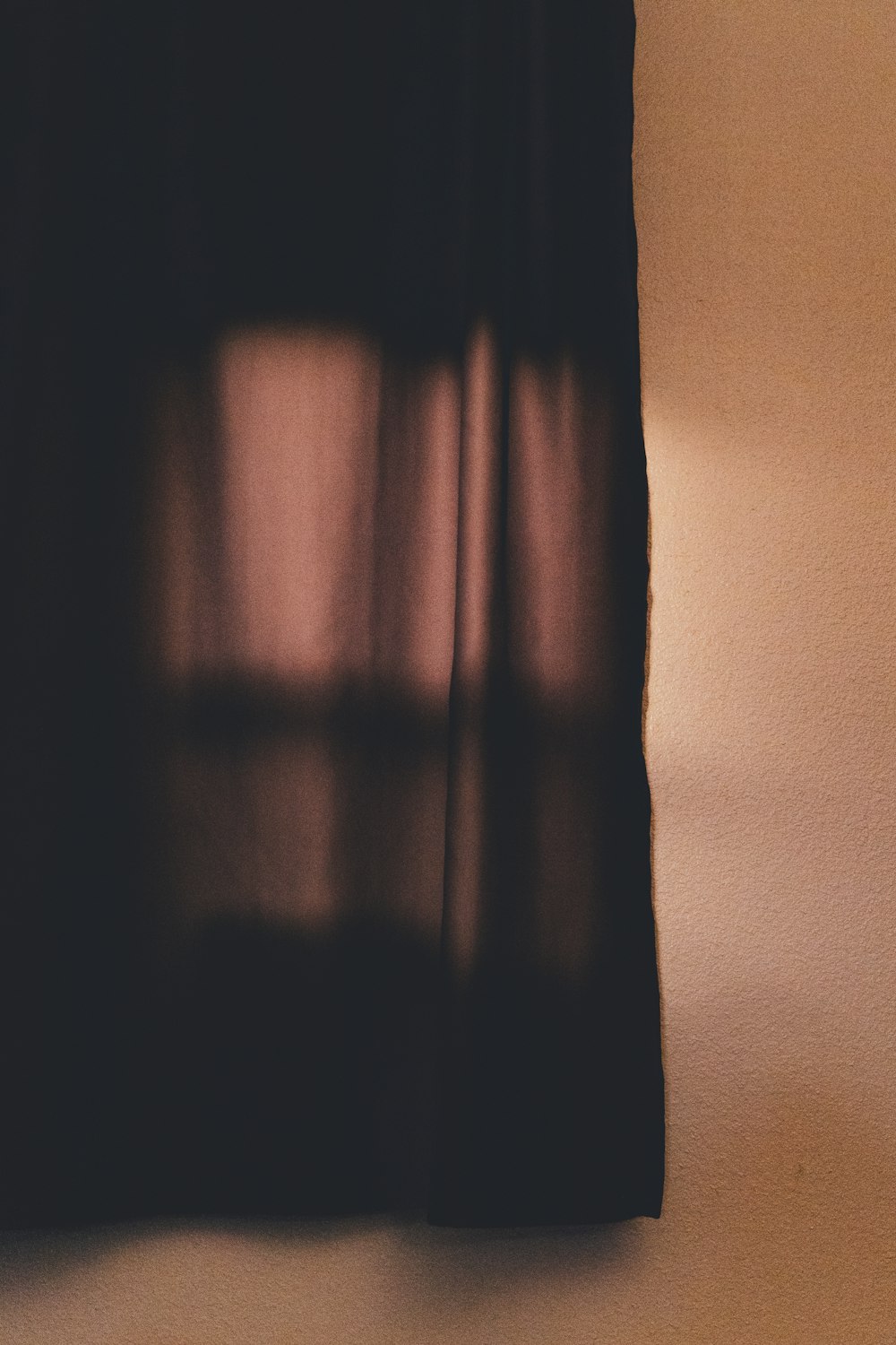 brown curtain near white wall