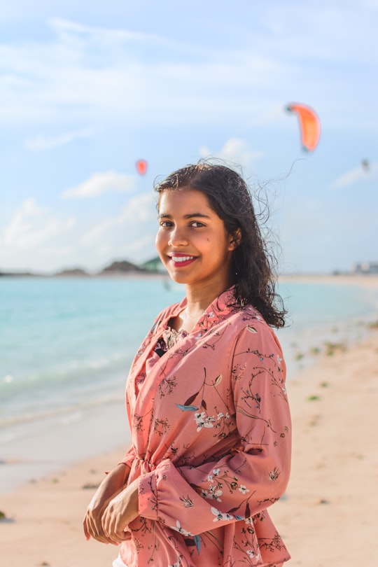 woman in pink and white floral robe standing on beach during daytime in Kulhudhuffushi Maldives