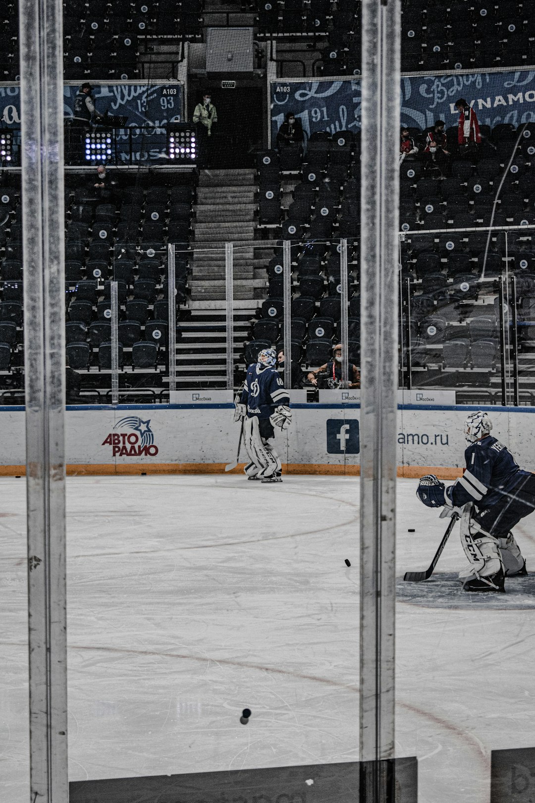 man in black jacket and black pants playing ice hockey