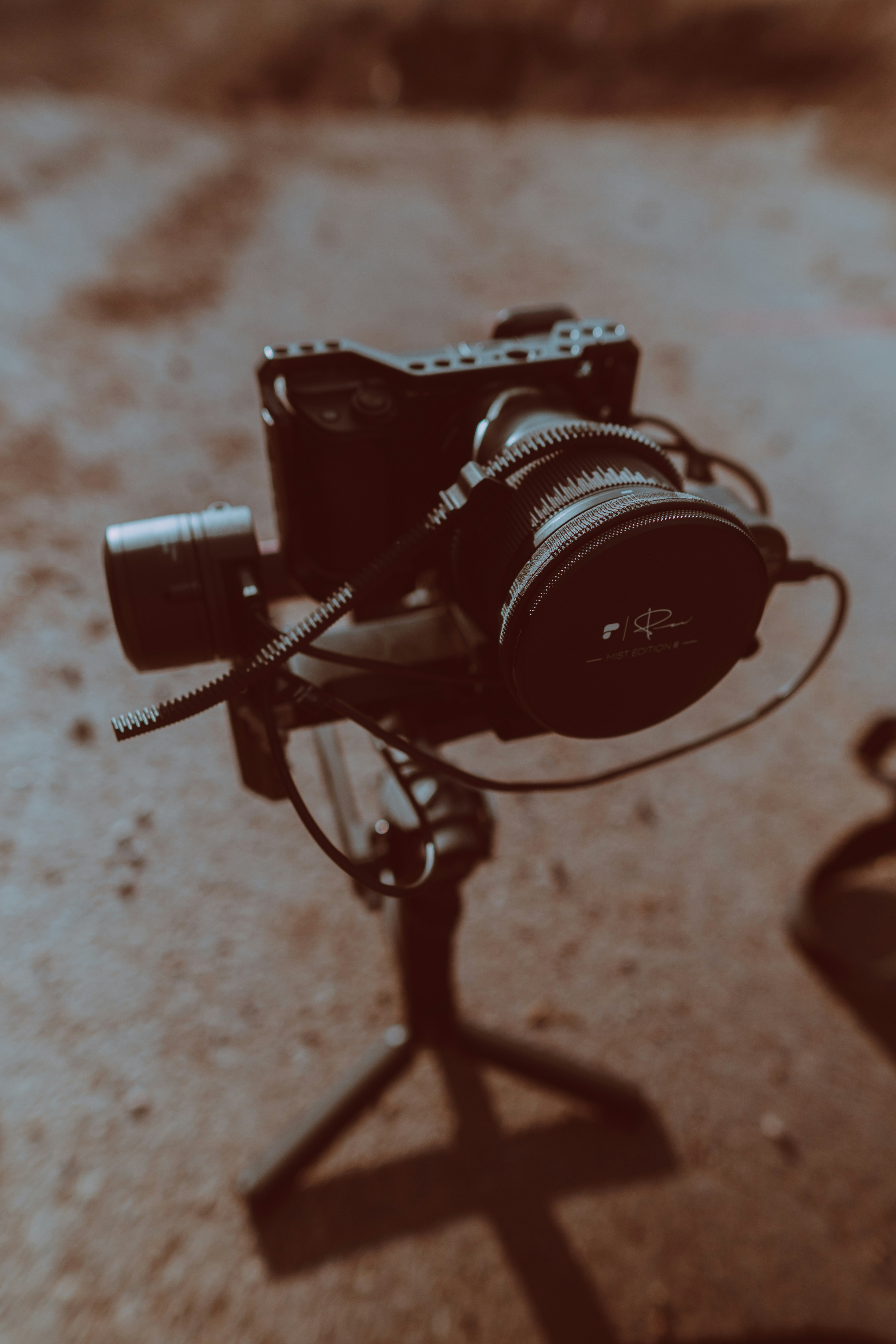 black and silver dslr camera on brown wooden table