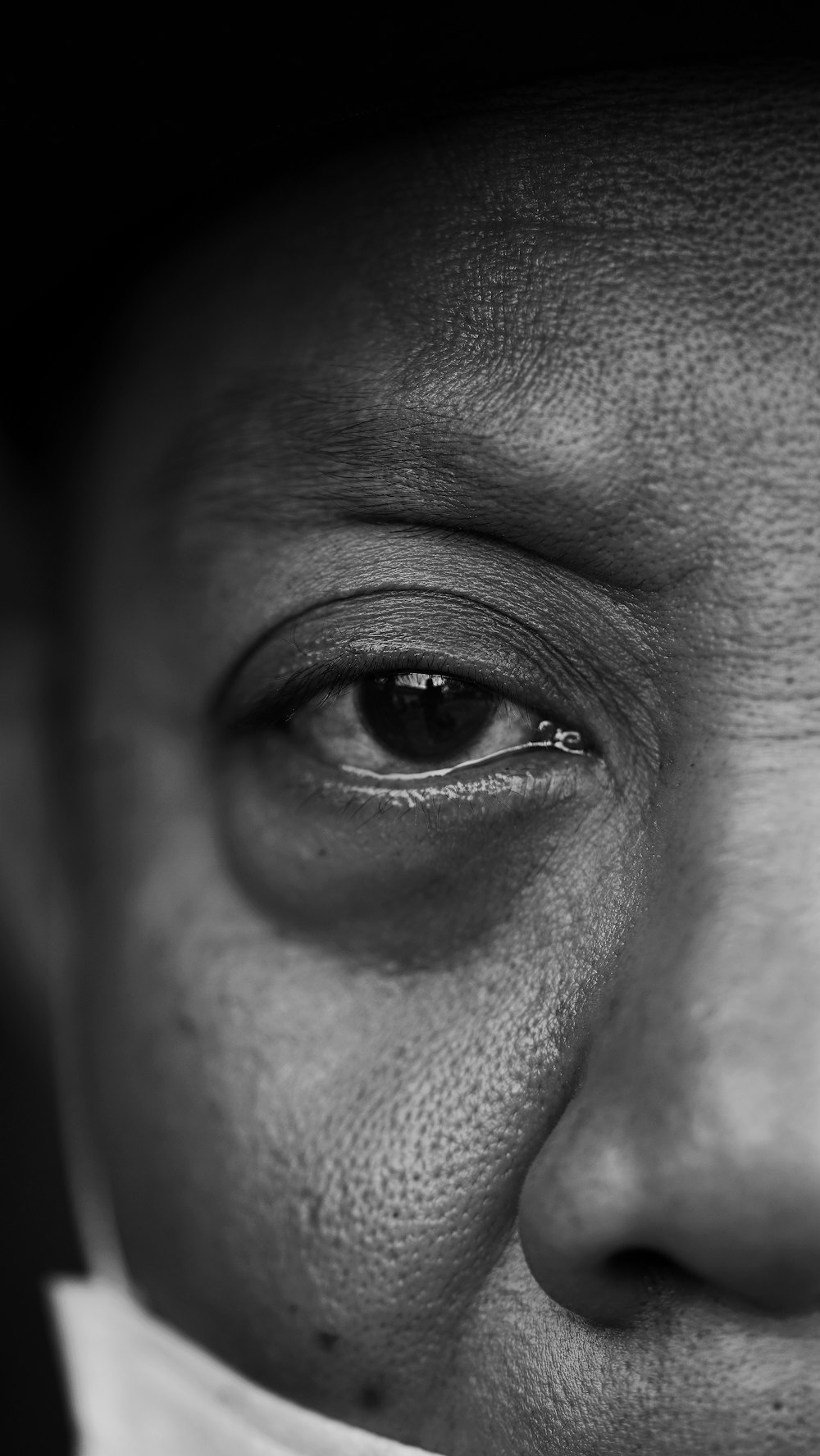 grayscale photo of persons eye