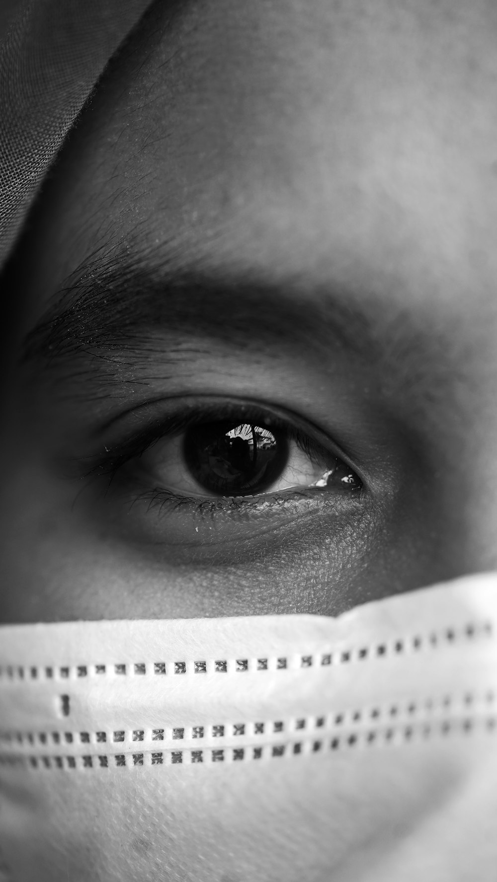 grayscale photo of person with white face mask