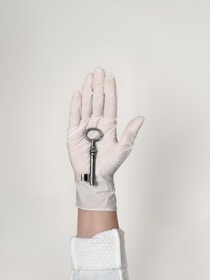 person wearing white shorts with black bracelet
