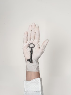 person wearing white shorts with black bracelet