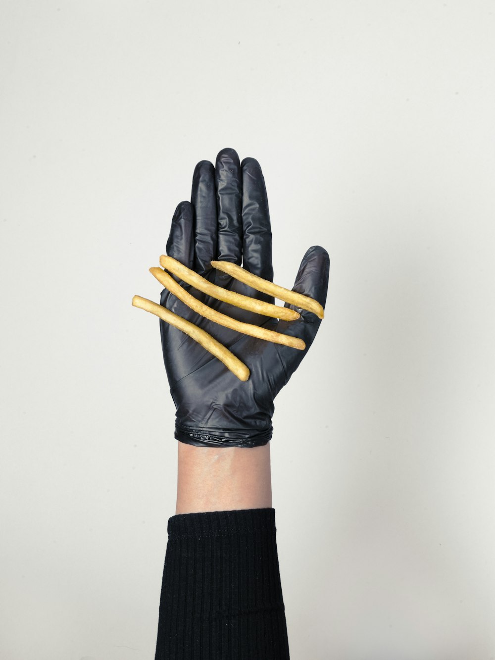 black leather gloves on white surface