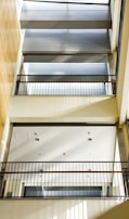 Interior view of a metal mezzanine with safety railings and industrial lighting.