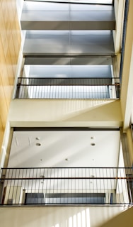 Interior view of a metal mezzanine with safety railings and industrial lighting.