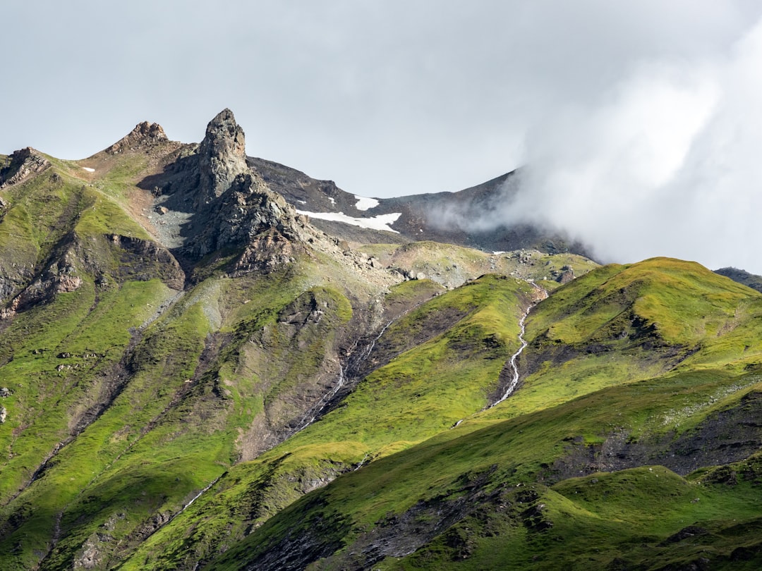 green and gray mountain under white clouds during daytime