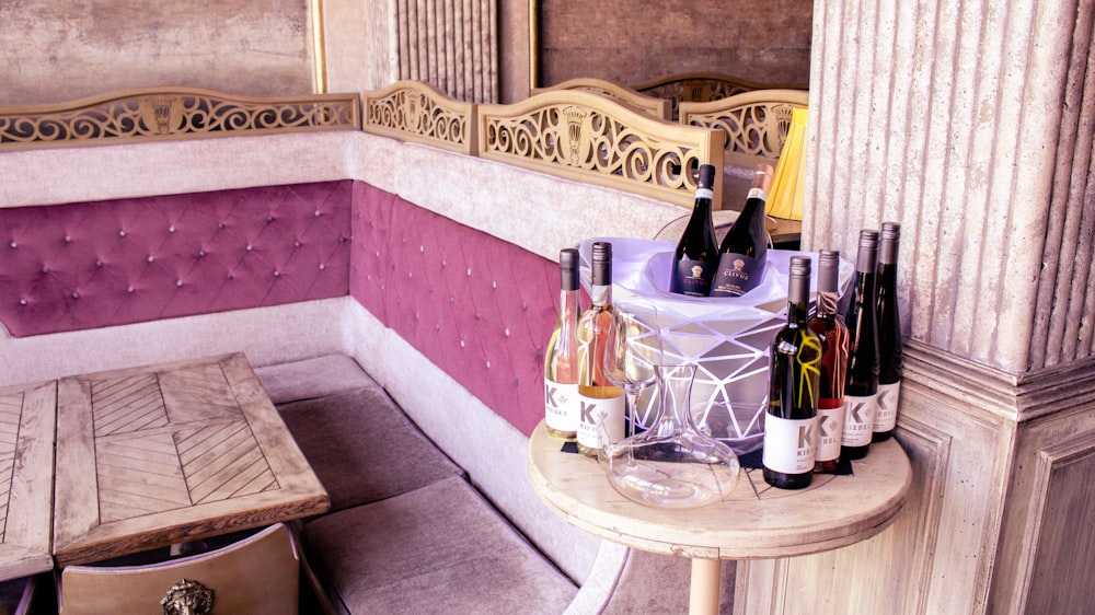 wine bottles on table with glass and glass