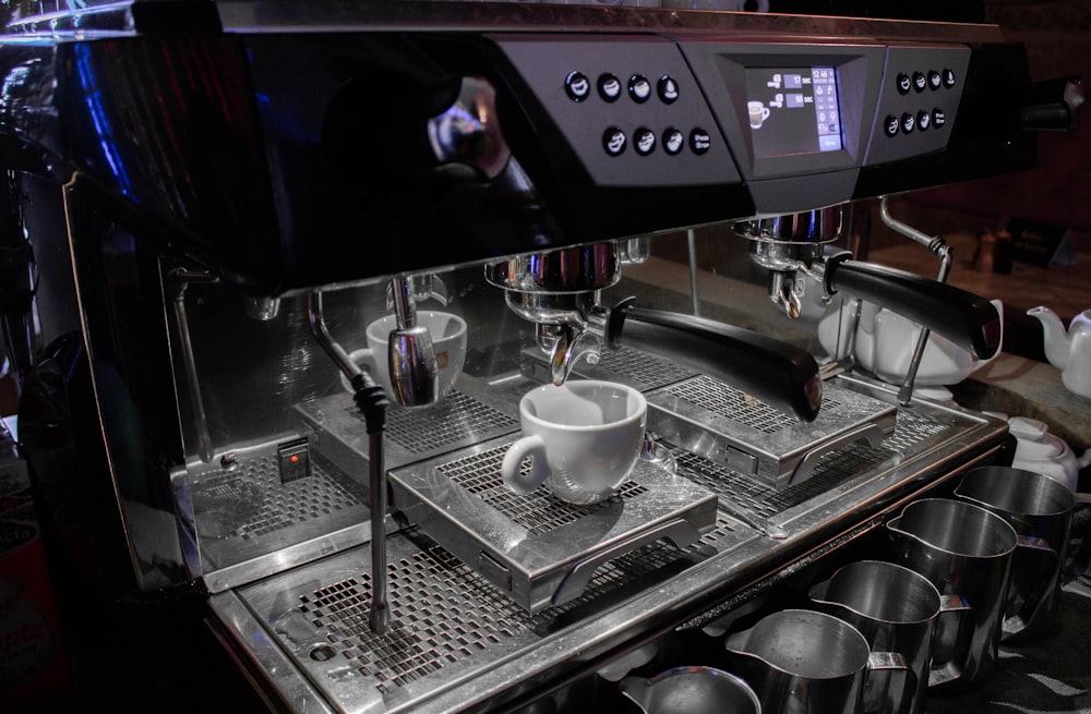 white ceramic mug on silver espresso machine