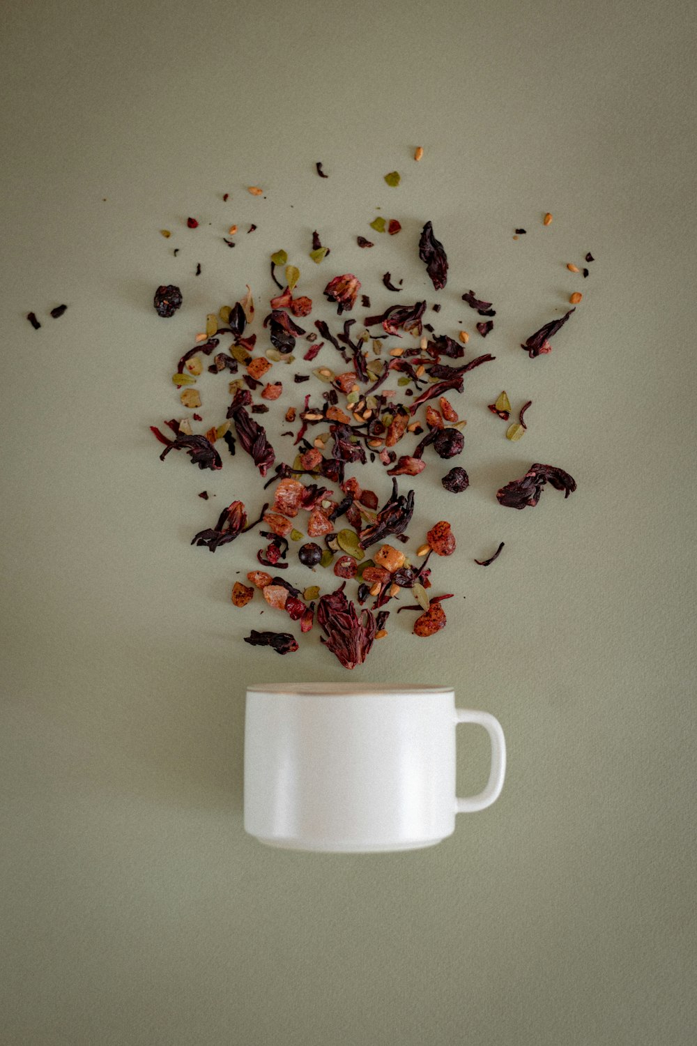 red and black flower petals on white ceramic mug