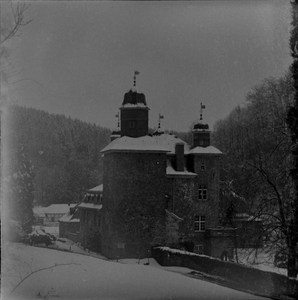 black concrete building on snow covered ground