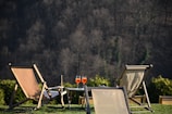 brown wooden folding chairs on green grass field during daytime